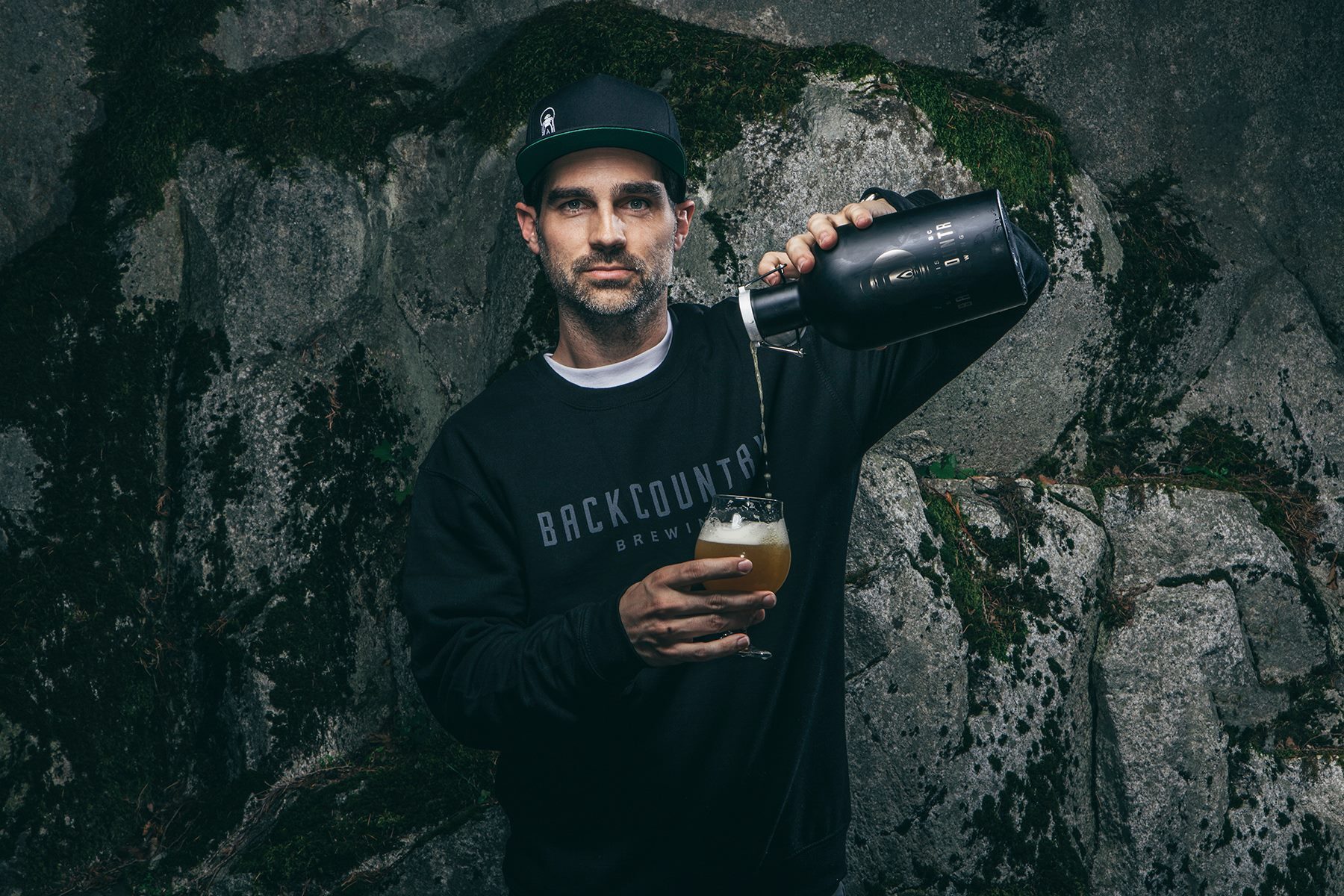 Brewer pouring craft beer outdoors