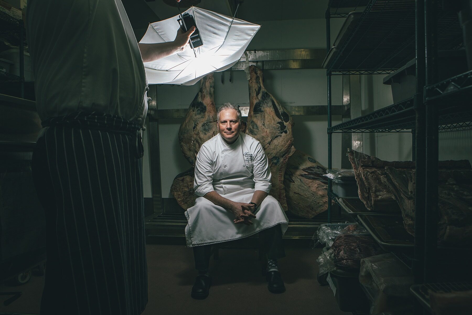 Chef seated in meat locker