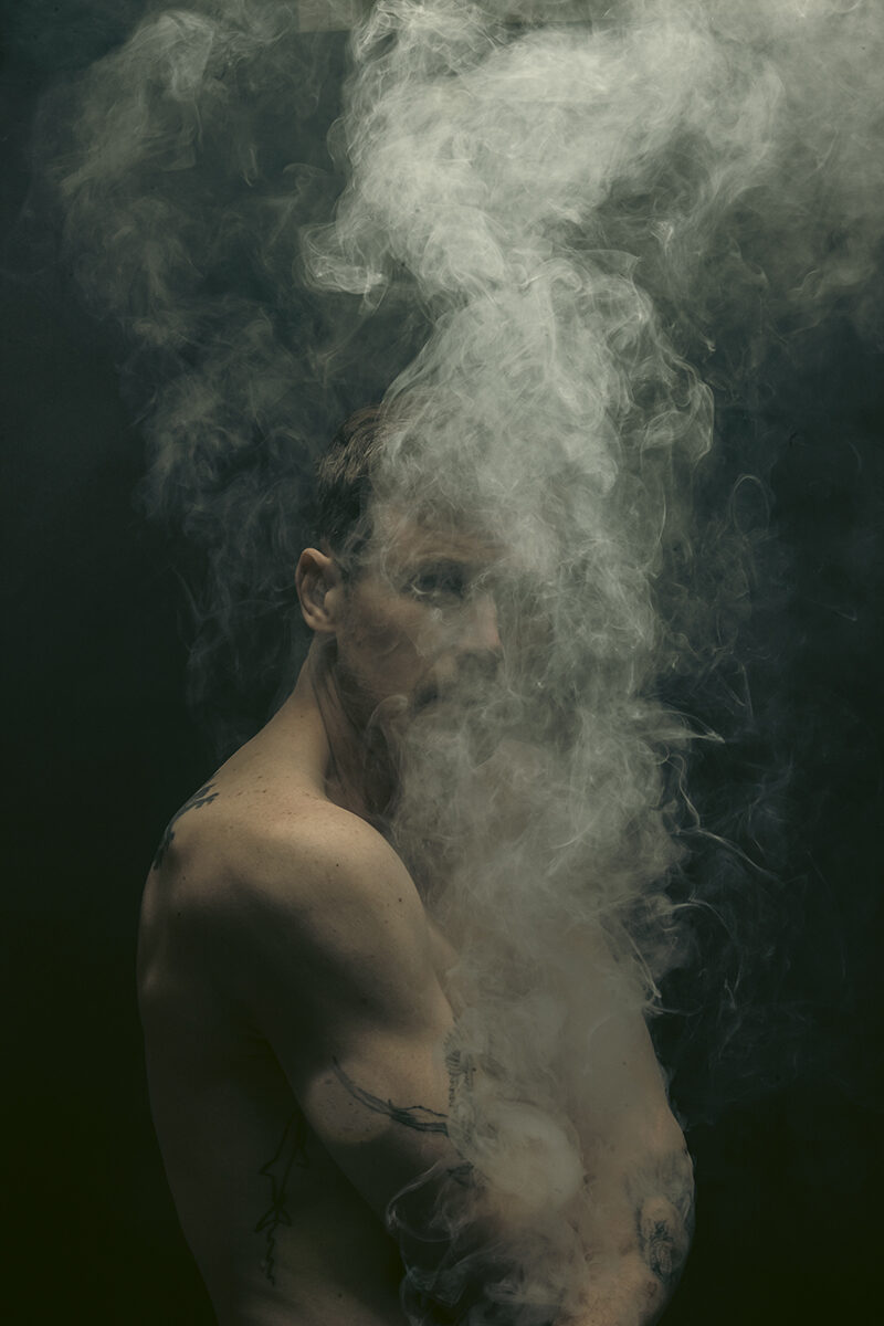 Portrait obscured by rising smoke