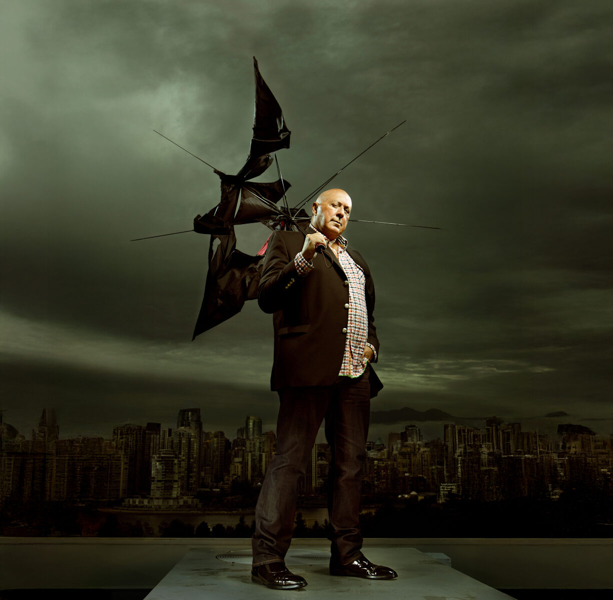 Man with broken umbrella, skyline