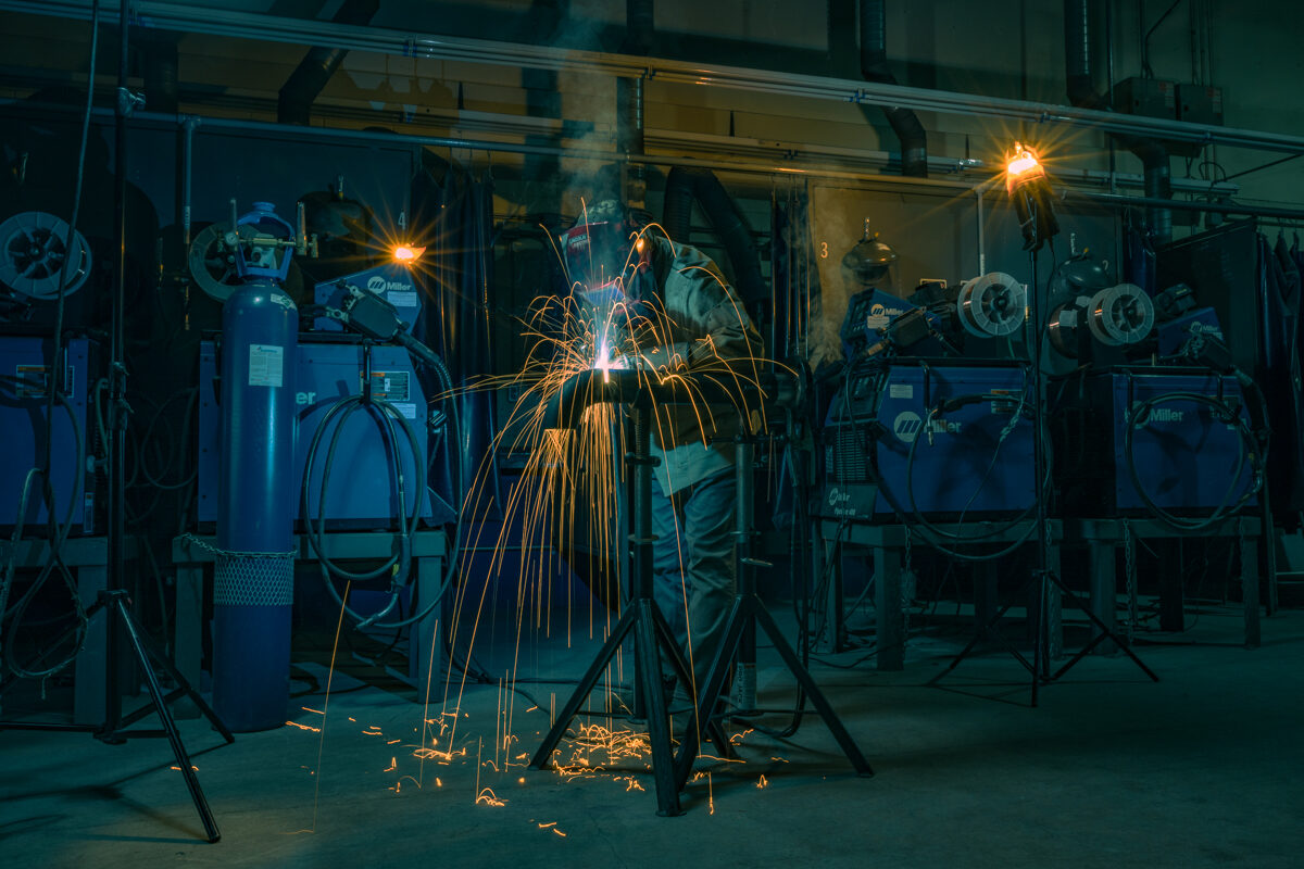 Welder with sparks in workshop